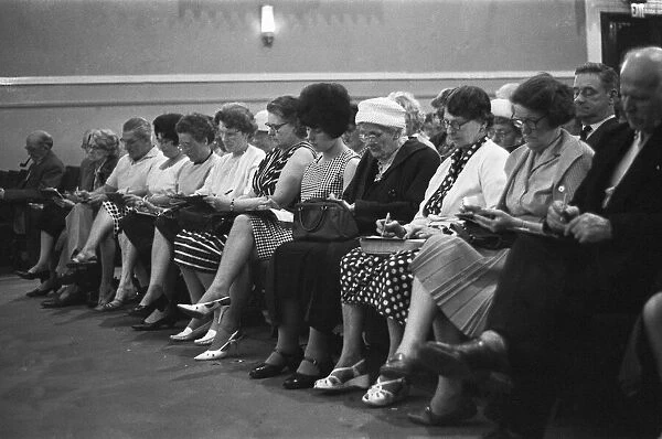 Playing bingo at the Gaiety Theatre, Cardiff. 31st July 1963