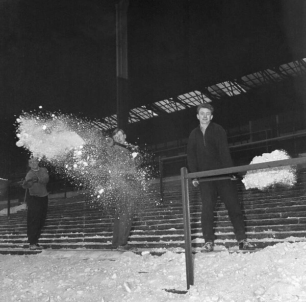 Playing staff help clear terraces of snow, at the Brittania Stadium, home of Stoke City