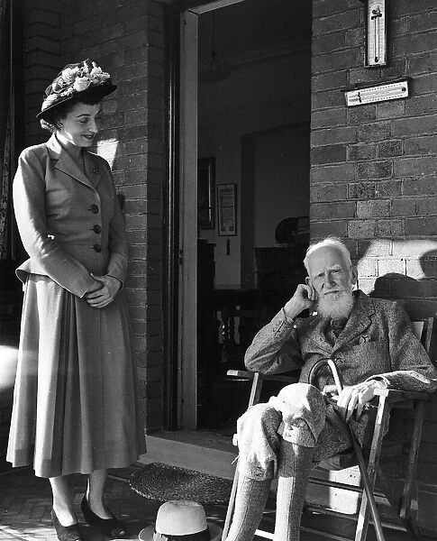 Playwright George Bernard Shaw visited by Miss Frances Rowe who came to offer him an