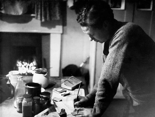 Poet Dylan Thomas pictured at his flat in Chelsea, London, 1945