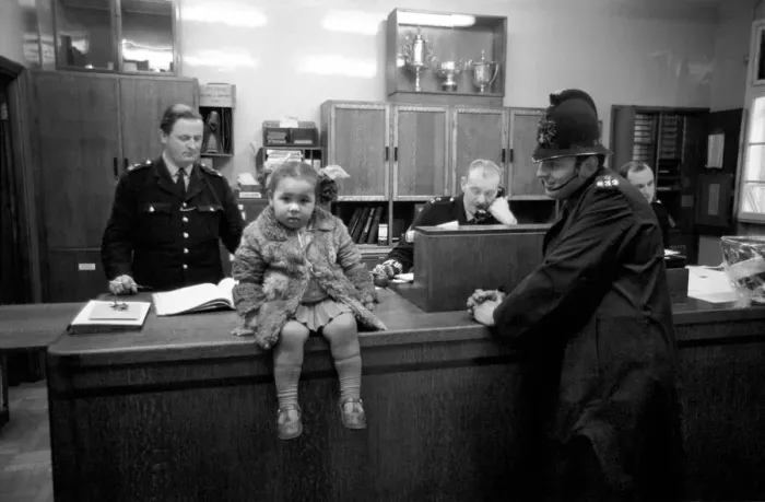 Framed Print : Police and Children. The scene is set in the enquiry office of Bishopsgate Police Station