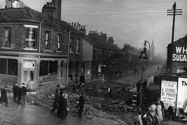 Police cordon off a crater caused by a German bomb outside The Albion Hotel at