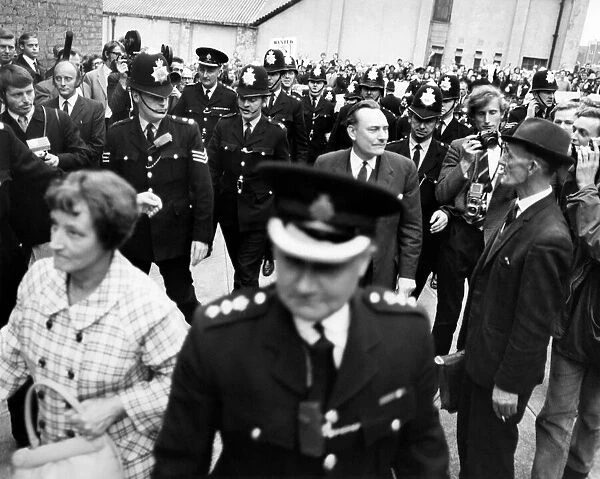 A police escort surrounds controversial Tory candidate Enoch Powell when he arrived to