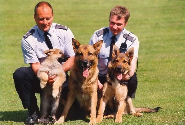 Police Officer Paul Dover (right) with puppy Asa and its police dog parents