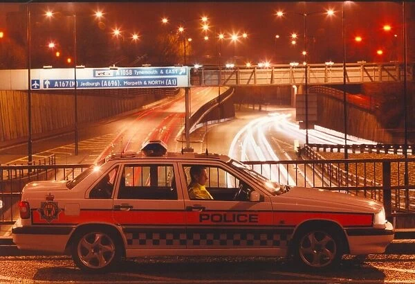 A police officer watches the traffic whizz by in his patrol car 01  /  06  /  95 circa