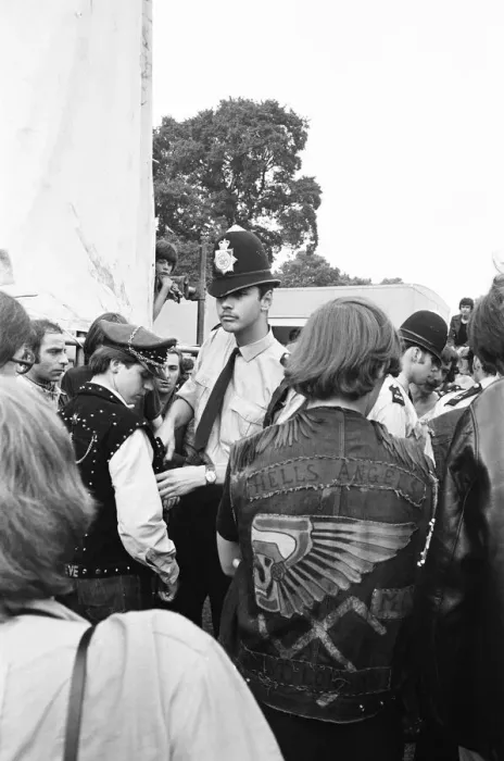 Framed Print : Police search the pockets of Hells Angels during the free Rolling Stones concert in Hyde