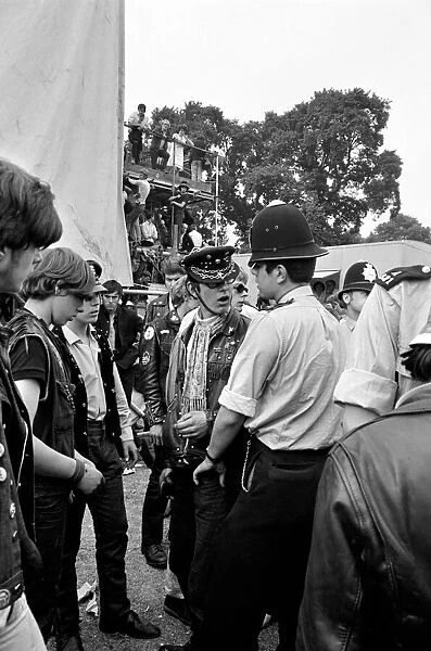Police talk with Hells Angels at The Rolling Stones on stage at their free concert in