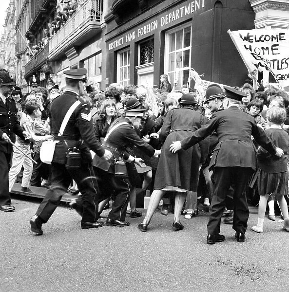 Police try to control fans in the streets of Liverpool before the premiere of the Beatles