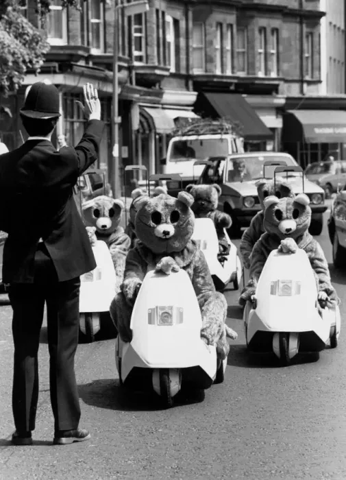 Framed Print : A policeman gestures to halt a rally of motor bears on C5s in London