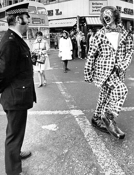 A policeman having a joke with a clown at the opening of the Newcastle Festival Parade in