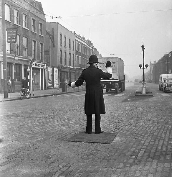 A policeman on point duty at the junction of Commercial Road with the junction of East