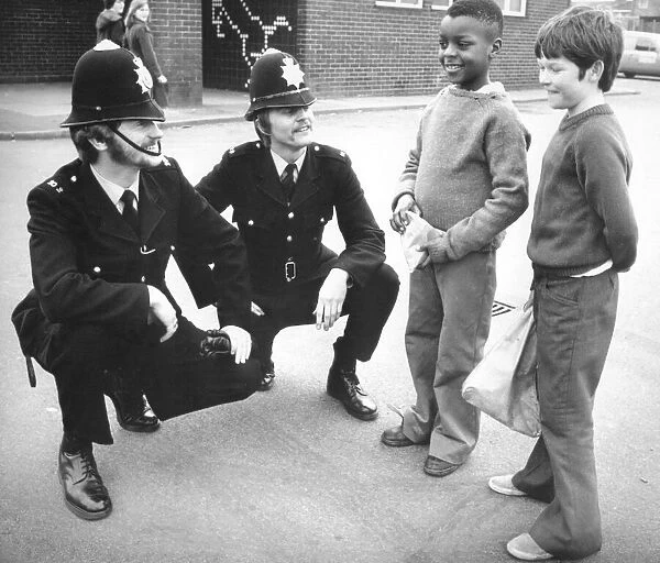 Two policemen on the beat in Coventry, stop to chat with a couple of young lads