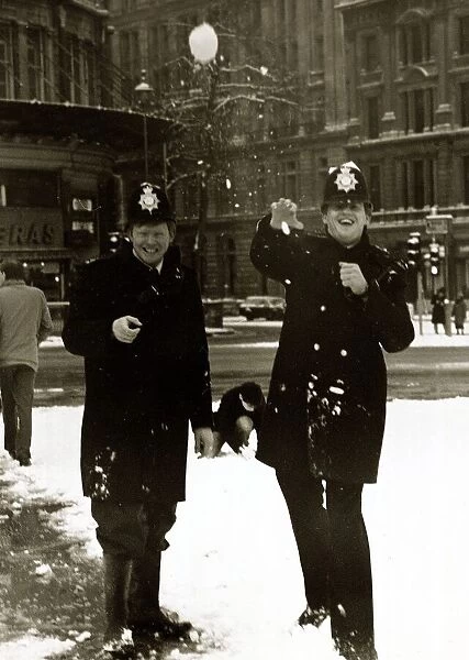 Policemen enjoying the snow in Trafalgar Square by joining in a snowball fight