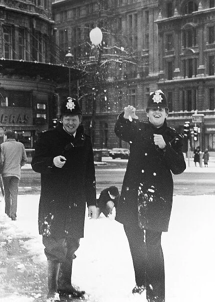 Policemen having a snow ball fight in London after a heavy snow fall January 1985