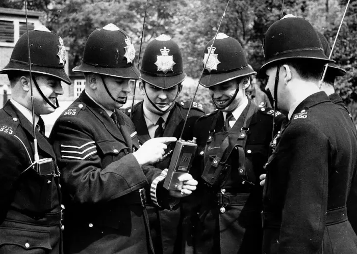 Framed Print : Policemen being shown how to operate their new walkie-talkie radios Framed Print : Policemen being shown how to operate their new walkie-talkie radios