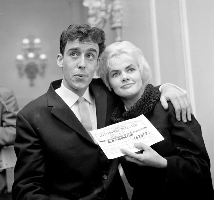 Framed Print : Pools winner Vivienne Nicholson smiles with her husband Keith Howard Nicholson holding a