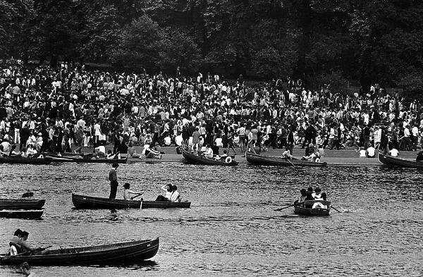 Pop fans and rowing boats on the Serpentine at The Rolling Stones concert at Hyde Park