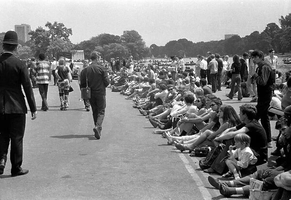 Pop fans sitting down near the Serpentine at The Rolling Stones concert at Hyde Park