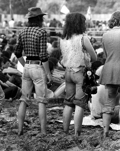 Pop Festival August 1977 Hippy Festival goers stand up to their ankles in mud with