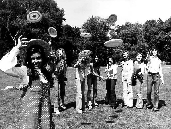 Pop girl Ayshea forms the target for some frisbee throwers. 23rd August 1973
