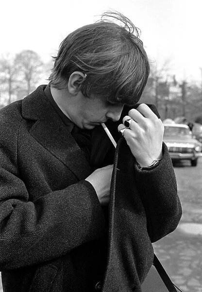 Pop Group The Beatles February 1964 Ringo Starr lighting a cigarette underneath