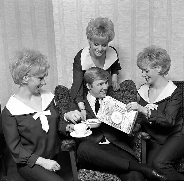 Pop group The Bell sisters from Liverpool serve cereal to Alan David