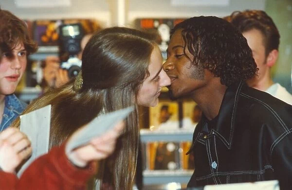 Pop group EYC, Damon Butler gives a young fan a kiss, at the Gateshead Metrocentre 12