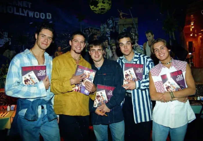 Framed Print : Pop group take that holding copies of their new book beore signing them for fans