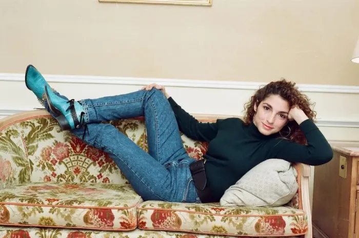Framed Print : Pop singer Gloria Estefan poses lying down on a sofa in her hotel room on a visit to