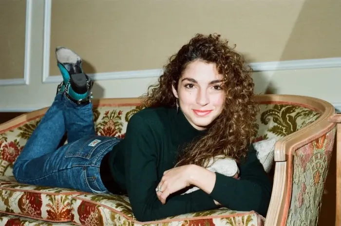 Framed Print : Pop singer Gloria Estefan poses lying down on a sofa in her hotel room on a visit to Framed Print : Pop singer Gloria Estefan poses lying down on a sofa in her hotel room on a visit to