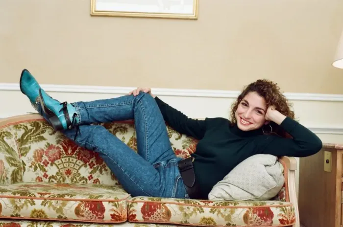 Framed Print : Pop singer Gloria Estefan poses lying down on a sofa in her hotel room on a visit to