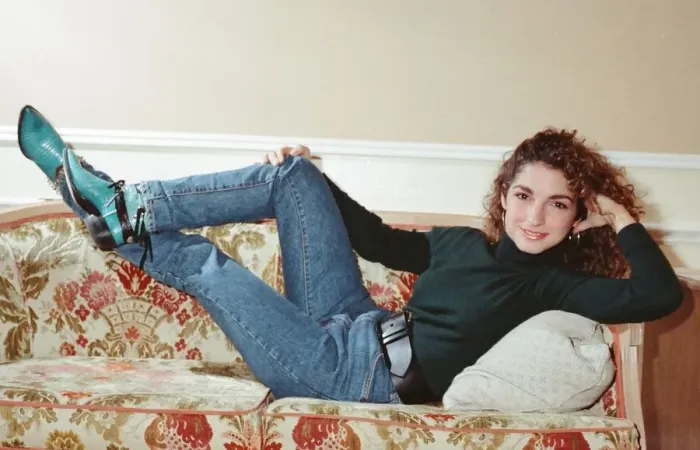 Framed Print : Pop singer Gloria Estefan poses lying down on a sofa in her hotel room on a visit to Framed Print : Pop singer Gloria Estefan poses lying down on a sofa in her hotel room on a visit to