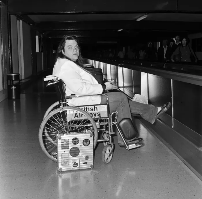 Framed Print : Pop singer Meat Loaf leaving Heathrow Airport in a wheelchair. 23rd June 1985 Framed Print : Pop singer Meat Loaf leaving Heathrow Airport in a wheelchair. 23rd June 1985