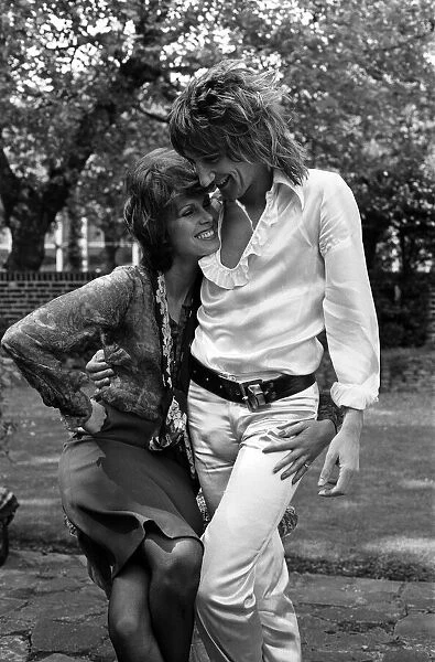 Pop singer Rod Stewart with his new girlfriend actress Joanna Lumley in her garden at her