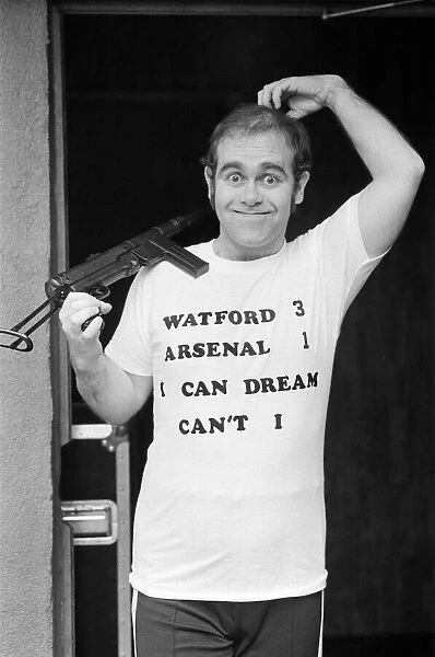 Pop star Elton John, also Chairman of Watford FC, pictured in Los Angeles giving his