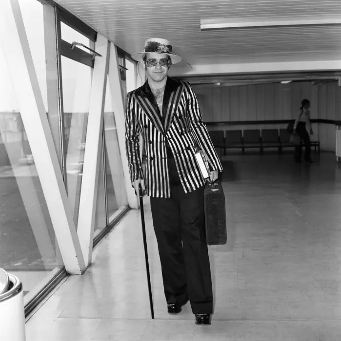 Framed Print : Pop star Elton John wearing a hat trimmed with flowers and feathers Framed Print : Pop star Elton John wearing a hat trimmed with flowers and feathers