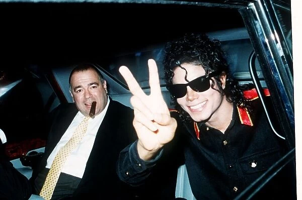 Pop star Michael Jackson gives the V sign as he arrives at Heathrow Airport for a concert