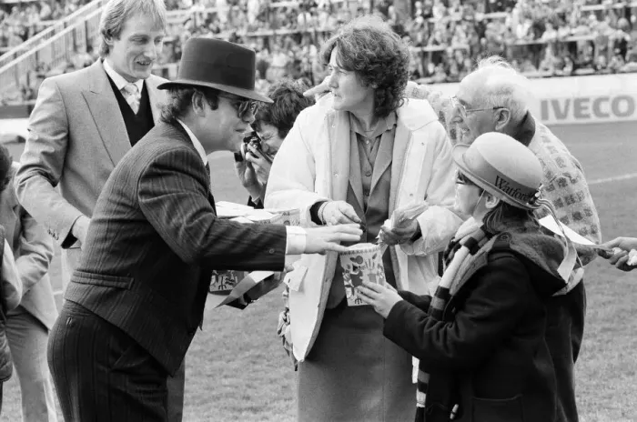 Framed Print : Pop star and Watford FC Chairman, Elton John, handing out Easter eggs to fans Framed Print : Pop star and Watford FC Chairman, Elton John, handing out Easter eggs to fans