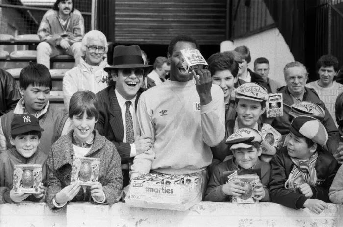 Framed Print : Pop star and Watford FC Chairman, Elton John, handing out Easter eggs to fans