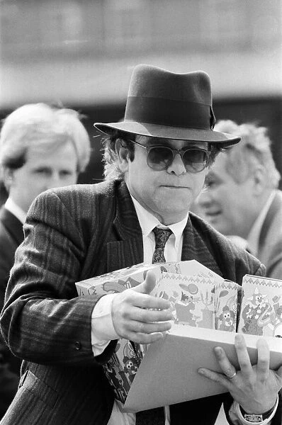 Pop star and Watford FC Chairman, Elton John, handing out Easter eggs to fans