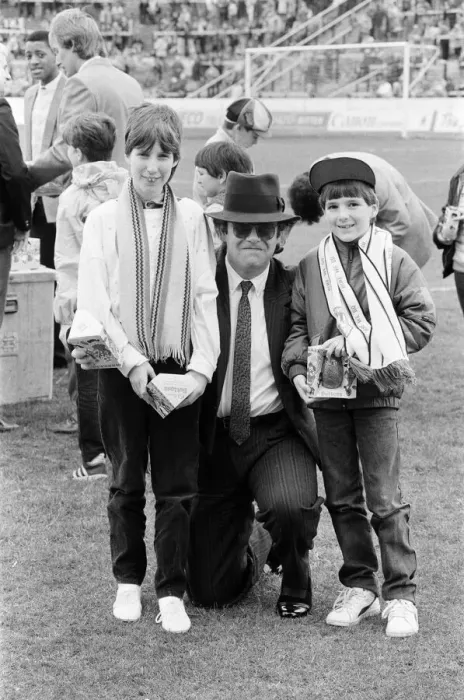 Framed Print : Pop star and Watford FC Chairman, Elton John, handing out Easter eggs to fans