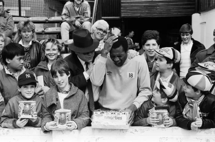 Framed Print : Pop star and Watford FC Chairman, Elton John, handing out Easter eggs to fans Framed Print : Pop star and Watford FC Chairman, Elton John, handing out Easter eggs to fans