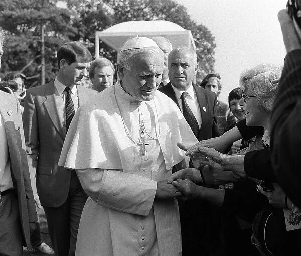 Pope John Paul II during his visit to Britain in 1982 walks among the people at one of
