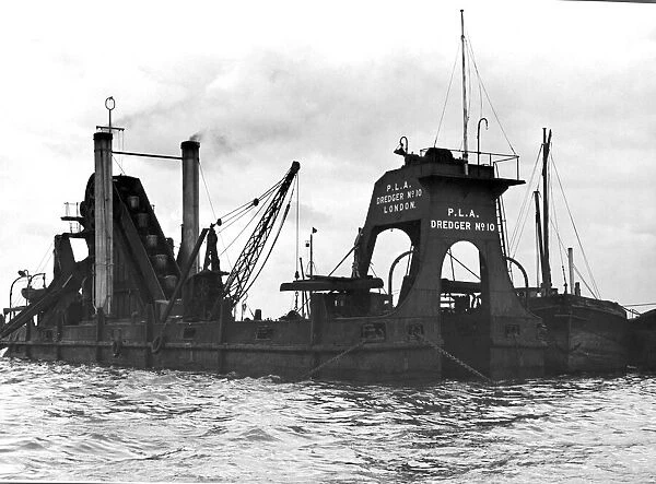 Port of London Authority Dredger Number 10 with barges alongside it at work in high water