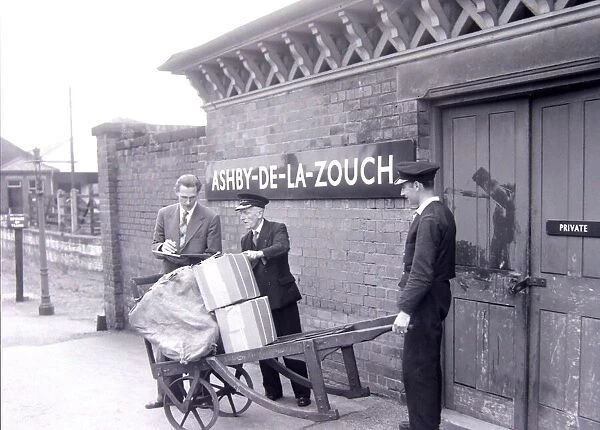 Porters checking parcels that have arrived by train at Ashby-de-la-Zouch railway station