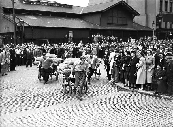Porters from Covent Garden Flower and Vegetable market race their carts around