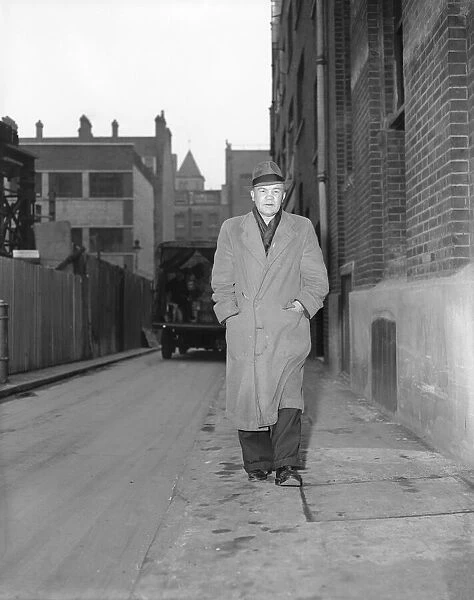 Portrait of boxer, Teddy Baldock, waking down a street. August 1956