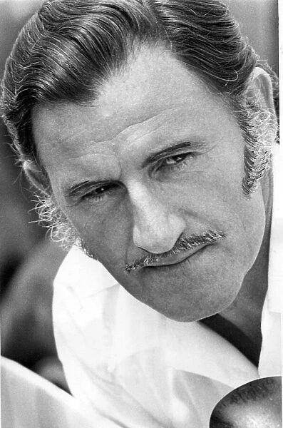 A portrait of Graham Hill pictured at Silverstone