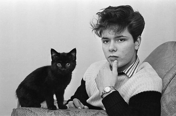 Portrait of rock and roll singer Cliff Richard with a cat. 3rd January 1959