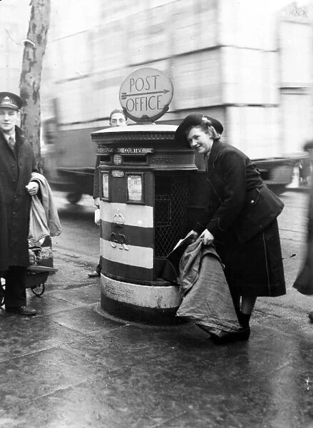 A post girl collecting letters in a London district. 1st February 1941
